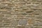 texture of bricks on the wall in the form of wild stone Background. Beige and brown tones with shadows and deep texture. Facing