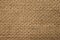 Texture of brown burlap, rough fabric with fibers for bags, macro