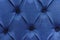 The texture of the carriage screed made of blue velor fabric, upholstery of upholstered furniture, headboard