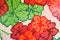Texture ceramic mosaic bright, red, pink, multi-colored flowers and green clover, hand-made neat square shape