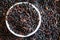 Texture of Coarse black rice in white plate The concept of proper nutrition and healthy lifestyle. Top view, close-up as backgroun