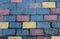 Texture of a colored brick of blue and yellow colors, the wall of the house
