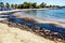 Texture of crude oil spill on sand beach from oil spill accident, Agios Kosmas bay, Athens, Greece, September 14 2017.