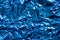 Texture of crumpled blue foil plastic.