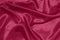 Texture of crumpled satin fabric, Pantone color of the year 2023 Viva Magenta