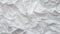 Texture of crumpled white paper, top view. Light gray crumpled paper background