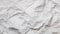 Texture of crumpled white paper, top view. Light gray crumpled paper background