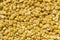 Texture of crushed yellow peas close-up, food background, substrate