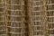 The texture of the curtains in the form of a brown mesh closeup