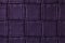 Texture of dark purple leather background with square pattern and stitch, macro