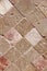 Texture of decorative brown ceramic tile with rhombus patterns, cracks and divorces