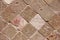 Texture of decorative brown ceramic tile with rhombus patterns, cracks and divorces