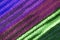 Texture of the Diagonal Stripe Patterns of Purple and Green Color Toned Alpaca Knitted Wool Fabric
