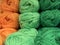 Texture of different sharpness from tangles of yarn in orange and green shades