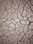 Texture of dry cracked earth. The desert background. The global shortage of water. Deep cracks in brown land as symbol of hot