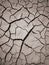 Texture of dry cracked earth. The desert background. The global shortage of water. Deep cracks in brown land as symbol of hot