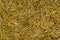 Texture of dry straw. Yellow dry hay background close-up.