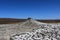 Texture of the earth`s surface and cracks next to the cold mud volcano. The layer of mud, which volcano erupts, quickly dries up