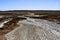 Texture of the earth`s surface and cracks next to the cold mud volcano. The layer of mud, which volcano erupts, quickly dries up