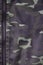 Texture of fabric with a camouflage painted in colors of the marsh. Army background image. Textile pattern of military camouflage