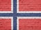 Texture of a flag of Norway on a pink  wall.