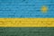 Texture of a flag of  Rwanda on a  brick wall.