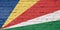 Texture of a flag of Seychelles on a  brick wall.