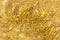 Texture of a flowing gold cosmetic product or acrylic paint