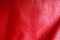 Texture of folds vivid red skin leather background