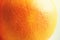 Texture of fresh bright orange peel, closeup, copy space. Macro of orange fruit. Citrus fruit background