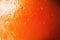 Texture of fresh bright orange peel, closeup, copy space. Macro of orange fruit. Citrus fruit background