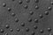 Texture of genuine leather with rivets close-up, gray color, for wallpaper or banner design. Fashionable background