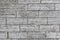 The texture of a gray stone wall made of rectangular marble blocks