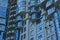 Texture of a gray wall with blue balconies and windows