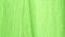 Texture of green fabric, close shot. Camera slowly sliding along green textile. Abstract background. Selective soft
