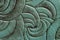 Texture of green mint genuine leather close-up, with embossed twirl curve, spiral trend pattern. Fashionable background