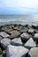 The texture of grey stone or background, the stones are scattered in waterfront on a beach, Waves washing over rocks with beautifu