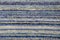 Texture of handmade carpet made on hand-loom, pattern of various blue and white vertical lines
