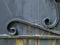 Texture of iron, two spiral curls on old gray door