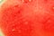 Texture of juicy pulp of red seedless watermelon closeup, full screen as background