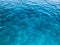 Texture light blue wet beautiful azure glowing transparent sea, ocean water, sea, ocean with small waves, light ripples. The backg