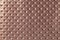 Texture of light brown leather background with capitone pattern, macro