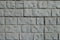 Texture of light gray unpainted brick veneer wall