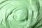 Texture of light green professional face mask as , closeup