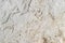 Texture of lime-whitewashed roughly plastered wall with dust