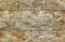 The texture of the limestone stone wall, building stone of beige-golden limestone