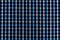 The texture of linen fabric in a large cage of blue, brown and white. Scottish tailoring material. Checkered fabric