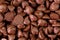 Texture macro of small chunks of sweetened chocolate chips background