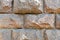 Texture made of huge large sturdy, strong, raised, convex, natural stone, granite crooked wall with seams and cracks. background