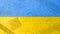 Texture of the military flag of Ukraine with patches and abrasions. Pain in the heart of Ukrainians. Blue and yellow flag